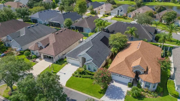 an aerial view of house with yard swimming pool and outdoor seating