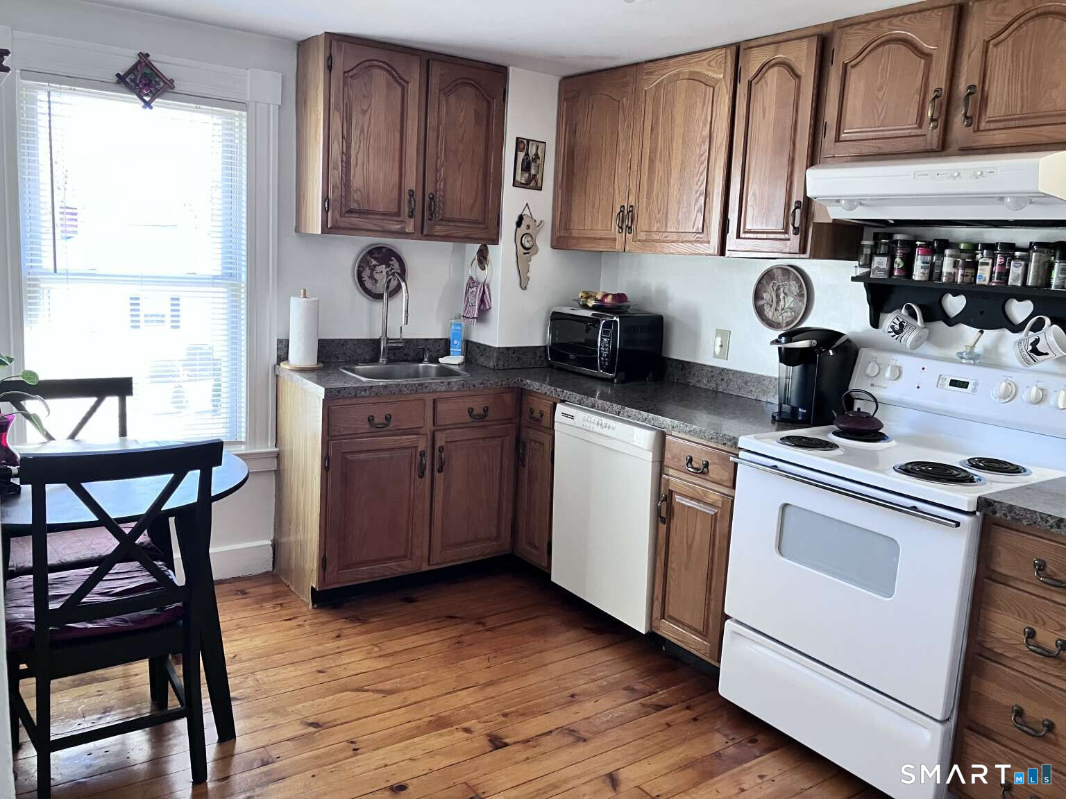 294 Church Street Guilford, CT 06437 - Photo 24 of 32 a kitchen with a stove a sink and cabinets
