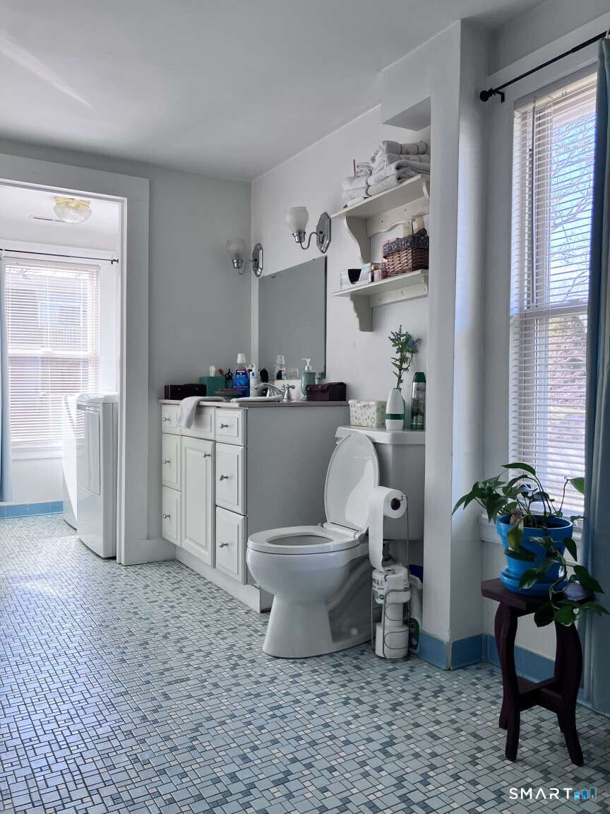 294 Church Street Guilford, CT 06437 - Photo 25 of 32 a bathroom with a toilet a sink and a window