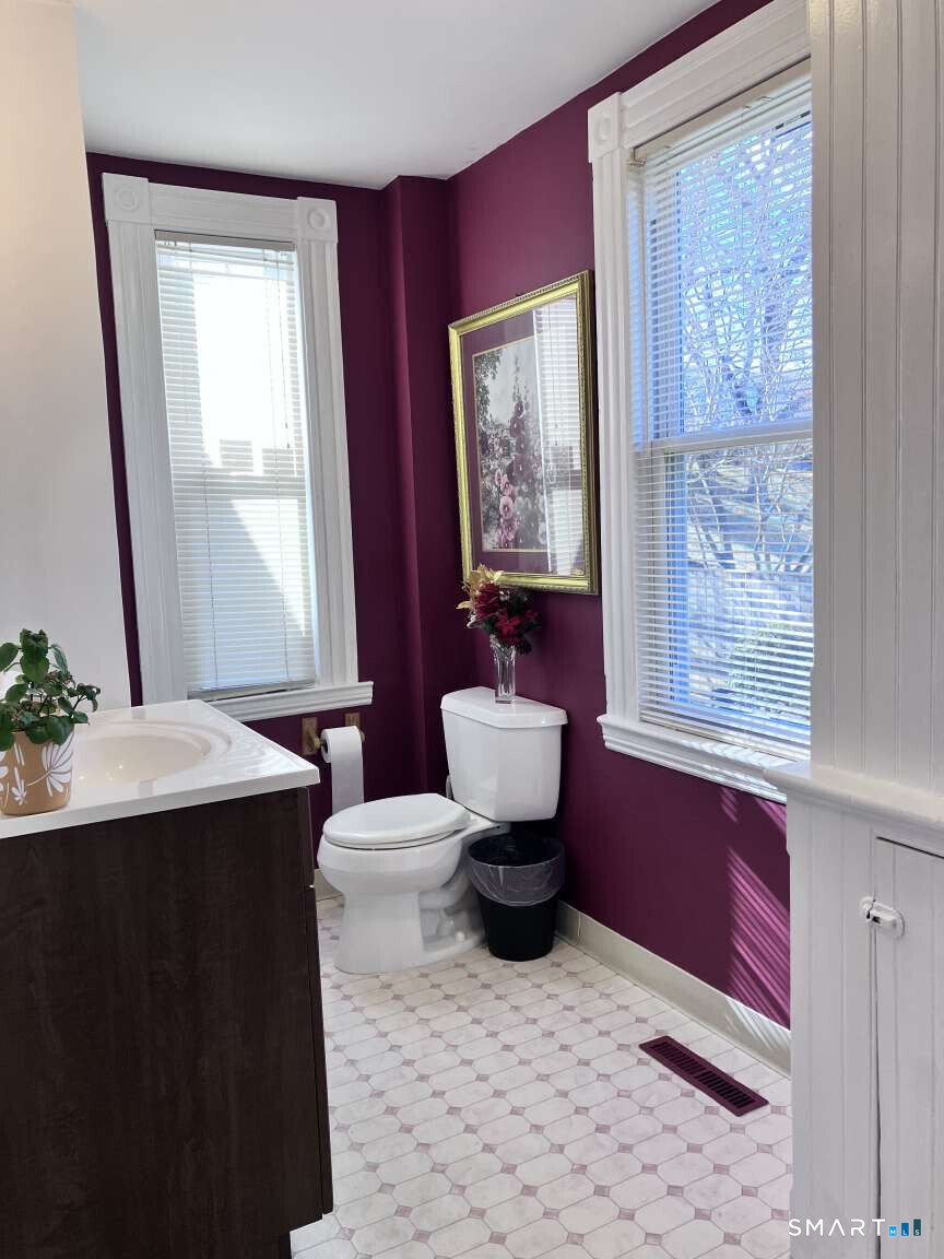 294 Church Street Guilford, CT 06437 - Photo 30 of 32 a bathroom with a toilet sink and mirror