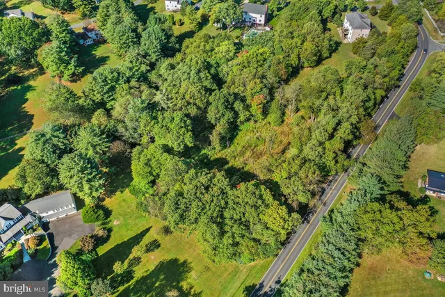 an aerial view of a houses with a yard