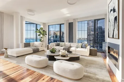 a living room with furniture and large windows