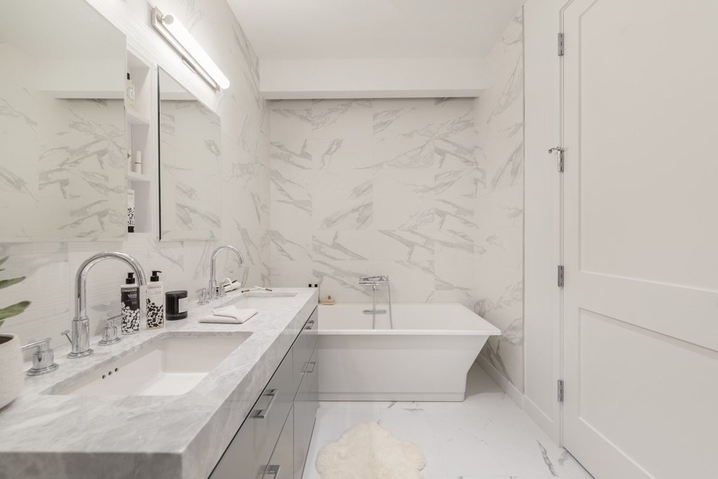 300 Pier 4 Blvd., Unit PHM Boston, MA 02210 - Photo 13 of 34 a bathroom with a sink and a bathtub