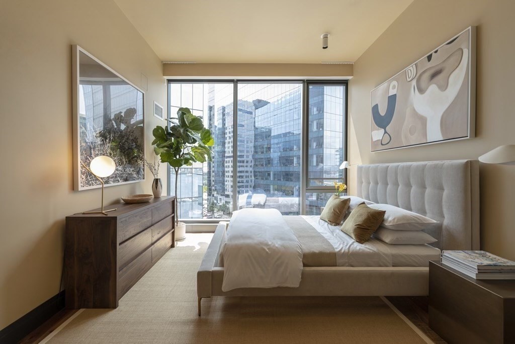 300 Pier 4 Blvd., Unit PHM Boston, MA 02210 - Photo 15 of 34 a bedroom with a large bed and a window