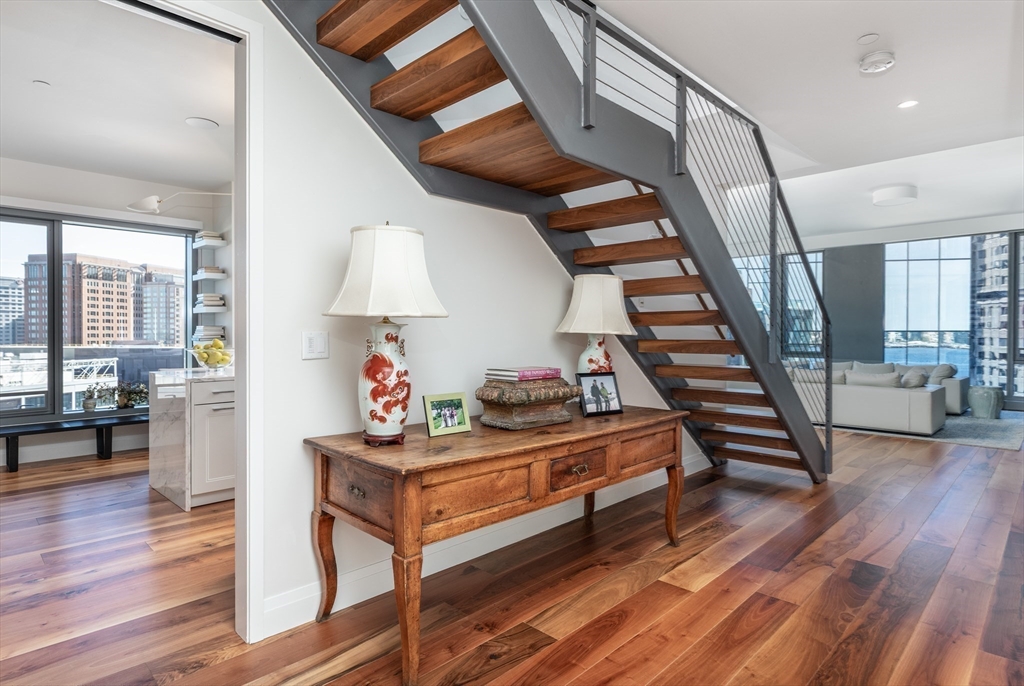 300 Pier 4 Blvd., Unit PHM Boston, MA 02210 - Photo 19 of 34 a room with lots of furniture and wooden floor