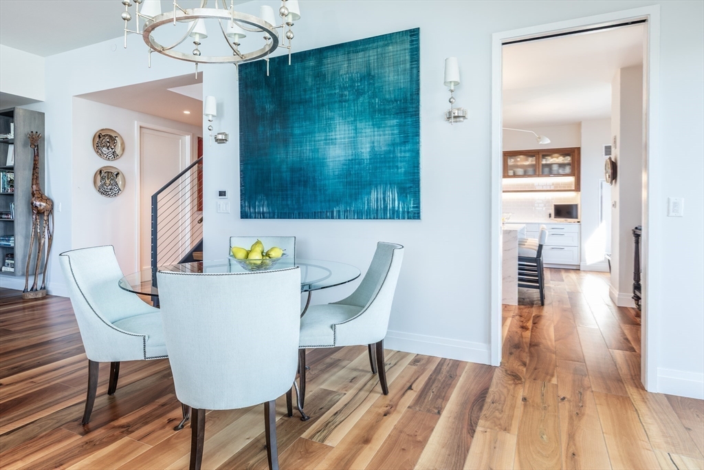300 Pier 4 Blvd., Unit PHM Boston, MA 02210 - Photo 2 of 34 a view of a dining room with furniture wooden floor and a chandelier