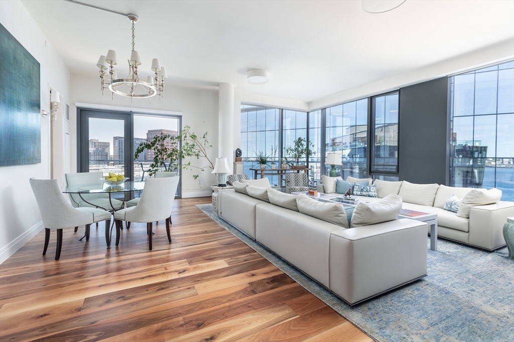 300 Pier 4 Blvd., Unit PHM Boston, MA 02210 - Photo 3 of 34 a living room with furniture and a chandelier