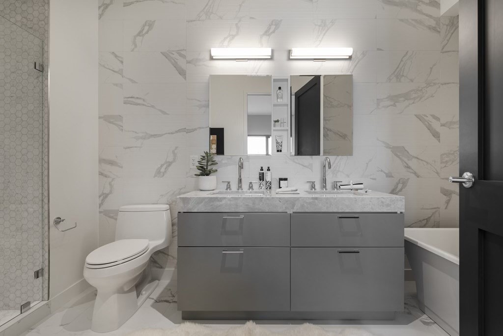 300 Pier 4 Blvd., Unit PHM Boston, MA 02210 - Photo 34 of 34 a bathroom with a toilet a sink and mirror