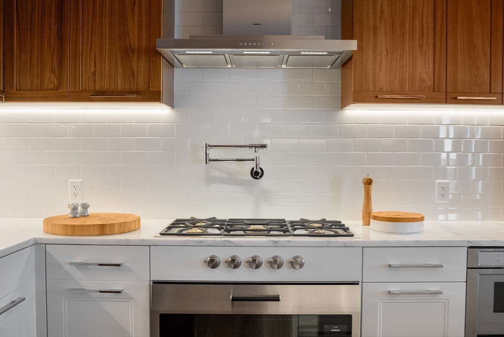 300 Pier 4 Blvd., Unit PHM Boston, MA 02210 - Photo 10 of 34 a stove top oven sitting inside of a kitchen