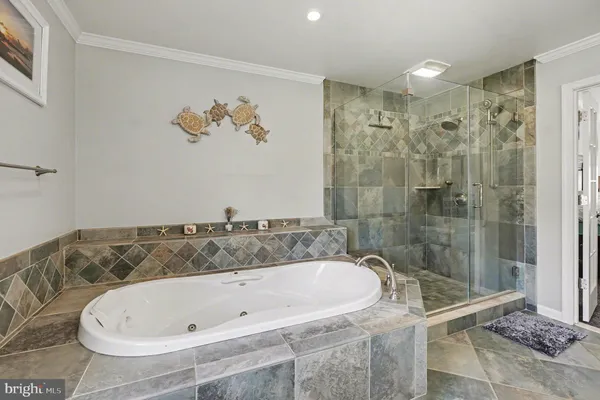 an empty room with a chandelier fan and windows