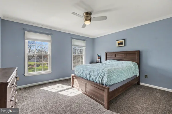 a living room with furniture a flat screen tv and a floor to ceiling window
