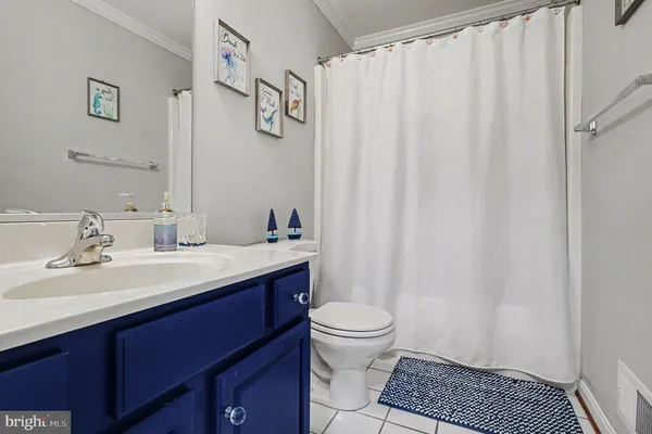 a bathroom with a granite countertop sink a toilet and a mirror
