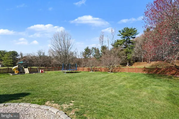 an aerial view of residential house with outdoor space and trees all around