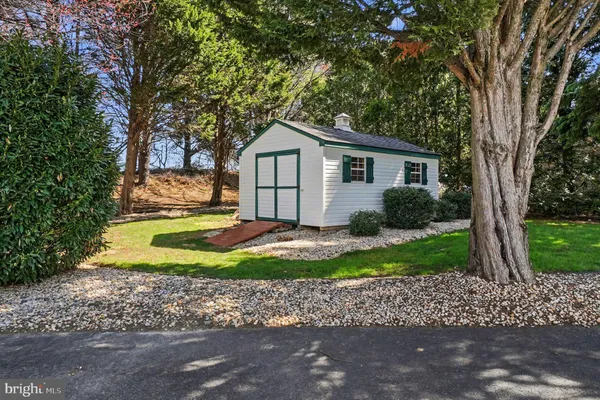 a front view of a house with a yard table and chairs