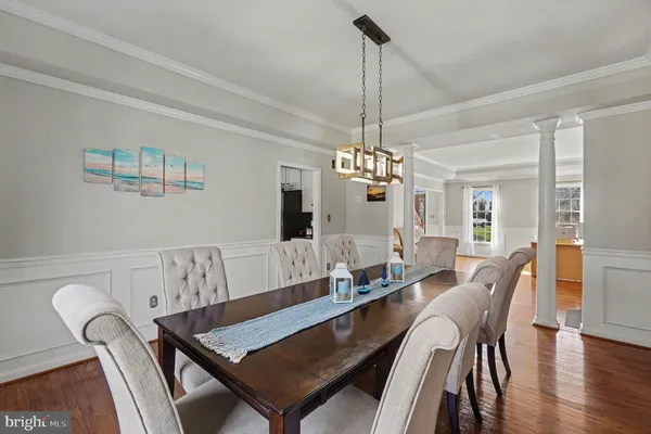a view of a dining room with furniture wooden floor and chandelier