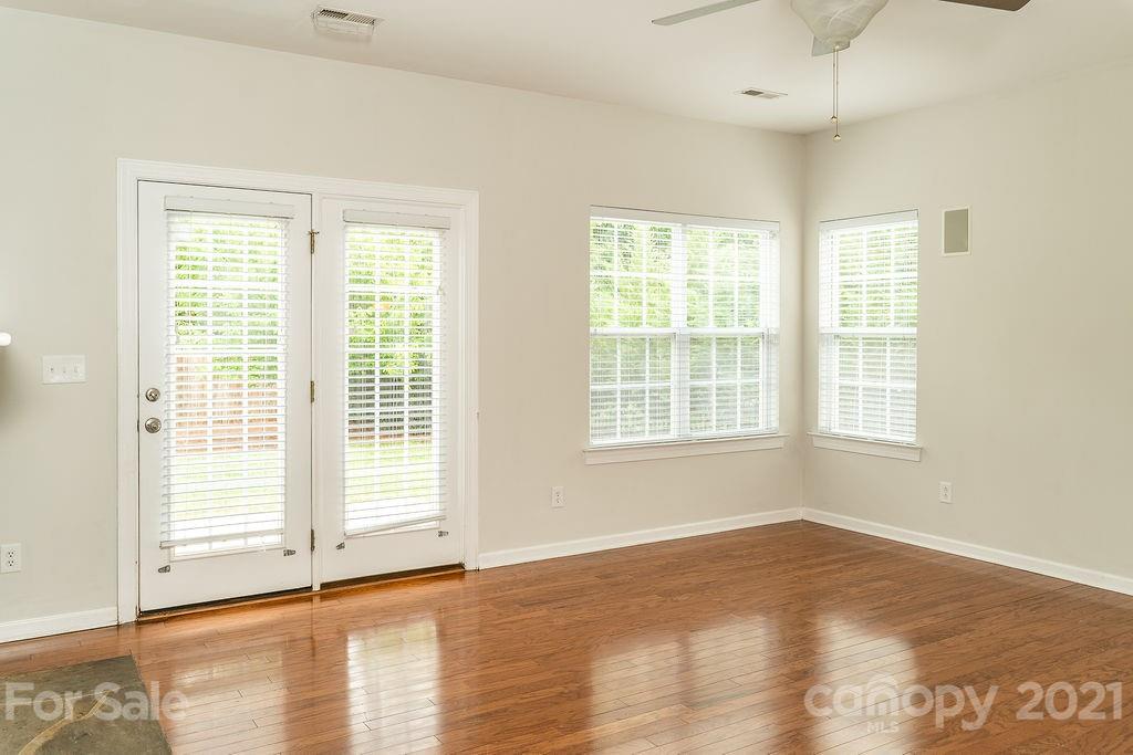 1032 Spanish Moss Road Indian Trail, NC 28079 - Photo 11 of 37 a view of an empty room with wooden floor and a window