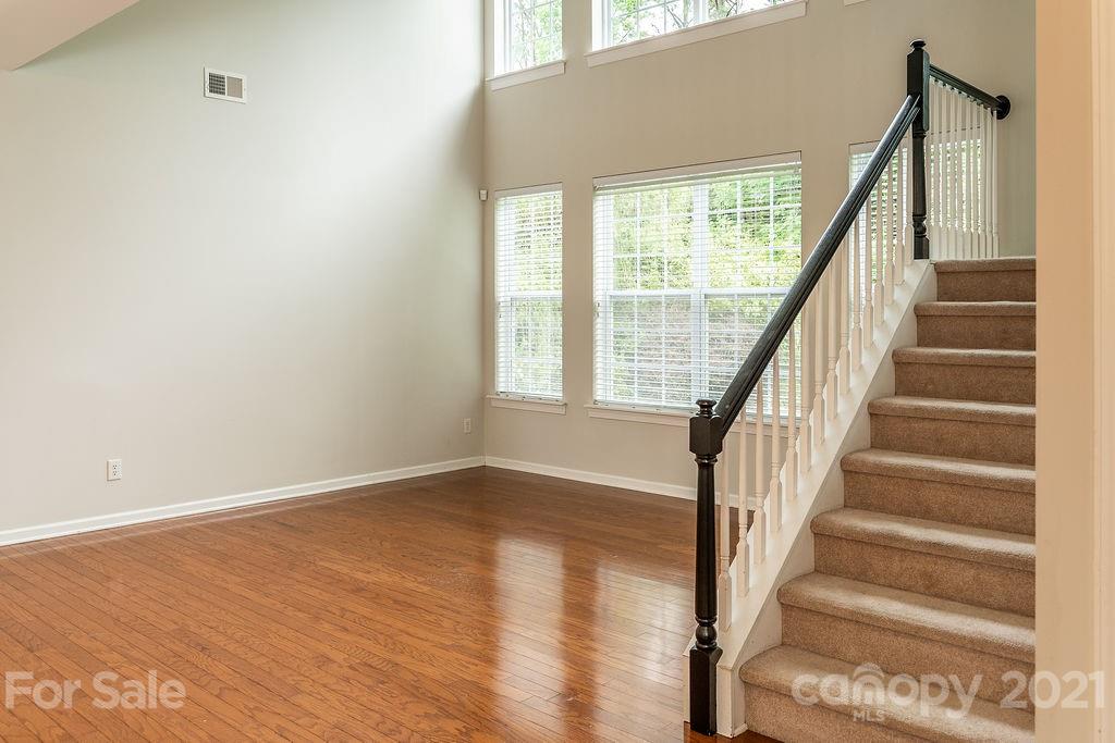 1032 Spanish Moss Road Indian Trail, NC 28079 - Photo 12 of 37 a view of an entryway with wooden floor and stairs