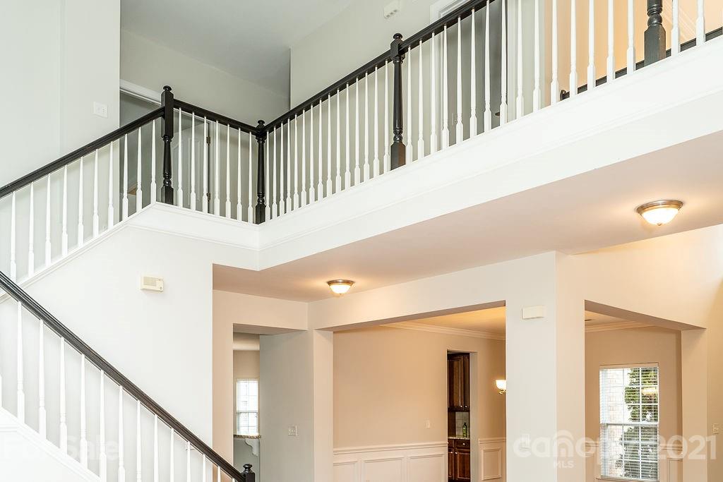 1032 Spanish Moss Road Indian Trail, NC 28079 - Photo 14 of 37 a view of staircase with lots of frames on wall and a window
