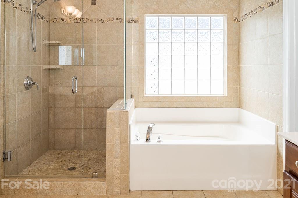 1032 Spanish Moss Road Indian Trail, NC 28079 - Photo 19 of 37 a bathroom with a bath tub and shower