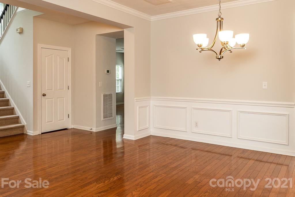 1032 Spanish Moss Road Indian Trail, NC 28079 - Photo 3 of 37 an empty room with wooden floor and white walls