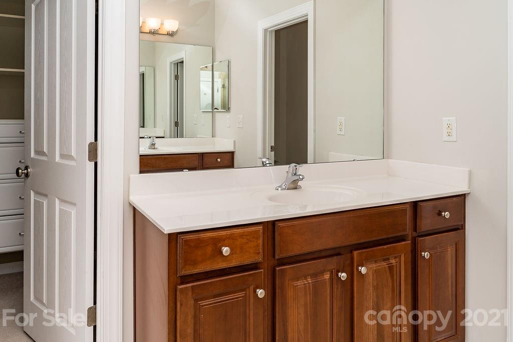 1032 Spanish Moss Road Indian Trail, NC 28079 - Photo 30 of 37 a bathroom with a sink and a mirror