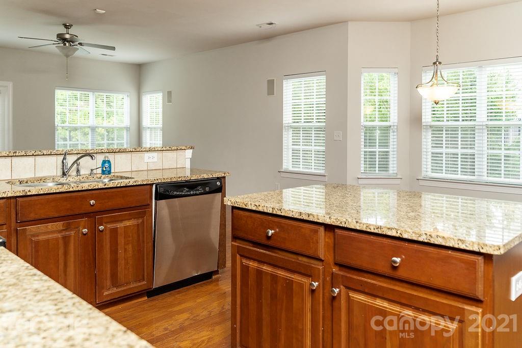 1032 Spanish Moss Road Indian Trail, NC 28079 - Photo 4 of 37 a kitchen with granite countertop a sink and a window