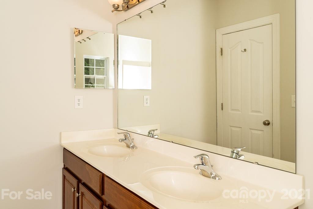 1032 Spanish Moss Road Indian Trail, NC 28079 - Photo 31 of 37 a bathroom with a sink and a mirror