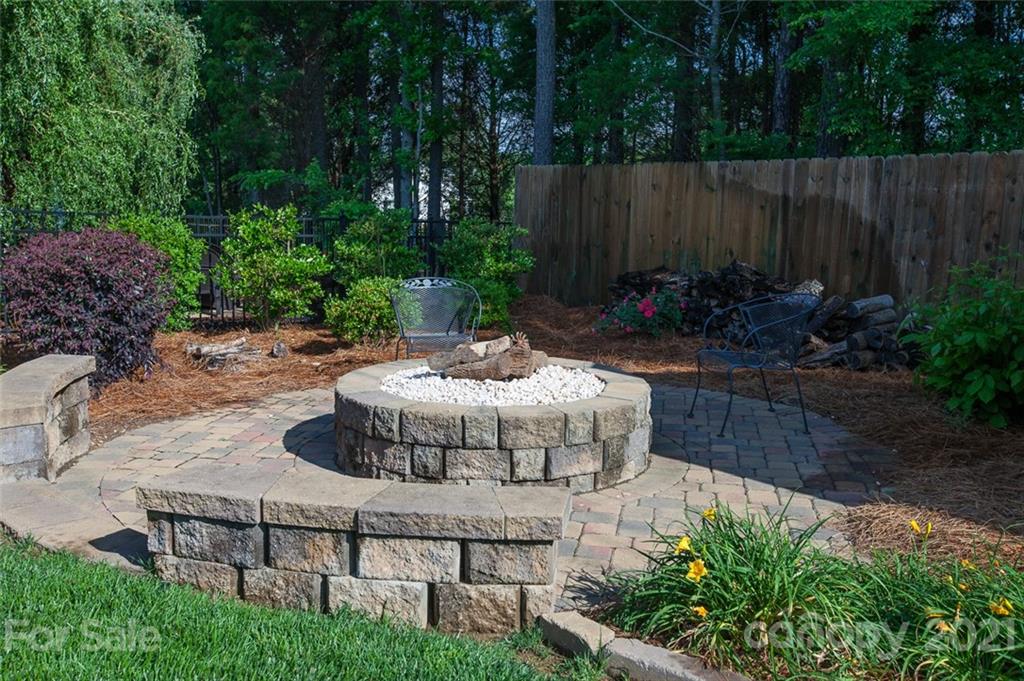 1032 Spanish Moss Road Indian Trail, NC 28079 - Photo 35 of 37 a view of a backyard with plants and a garden