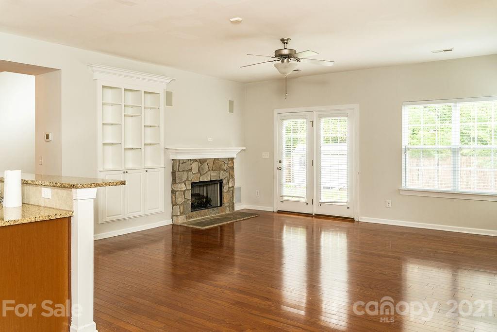 1032 Spanish Moss Road Indian Trail, NC 28079 - Photo 8 of 37 a view of a livingroom with a fireplace wooden floor and windows