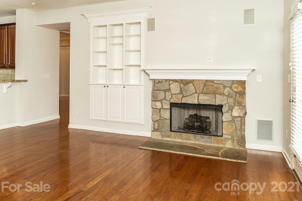 1032 Spanish Moss Road Indian Trail, NC 28079 - Photo 9 of 37 a view of an empty room with wooden floor and a fireplace