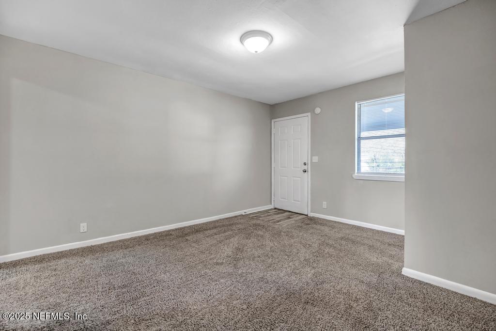 5352 Vick Avenue Jacksonville, FL 32254 - Photo 7 of 26 an empty room with windows