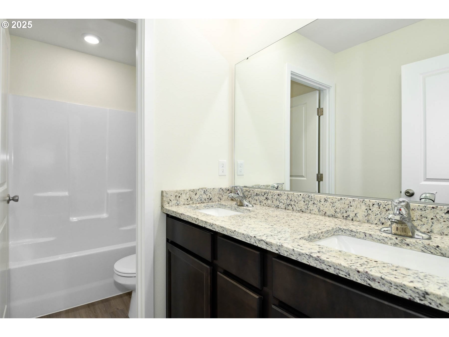 3989 Southwest Duniway Lane Gresham, OR 97080 - Photo 12 of 19 a bathroom with a granite countertop sink a toilet and bathtub