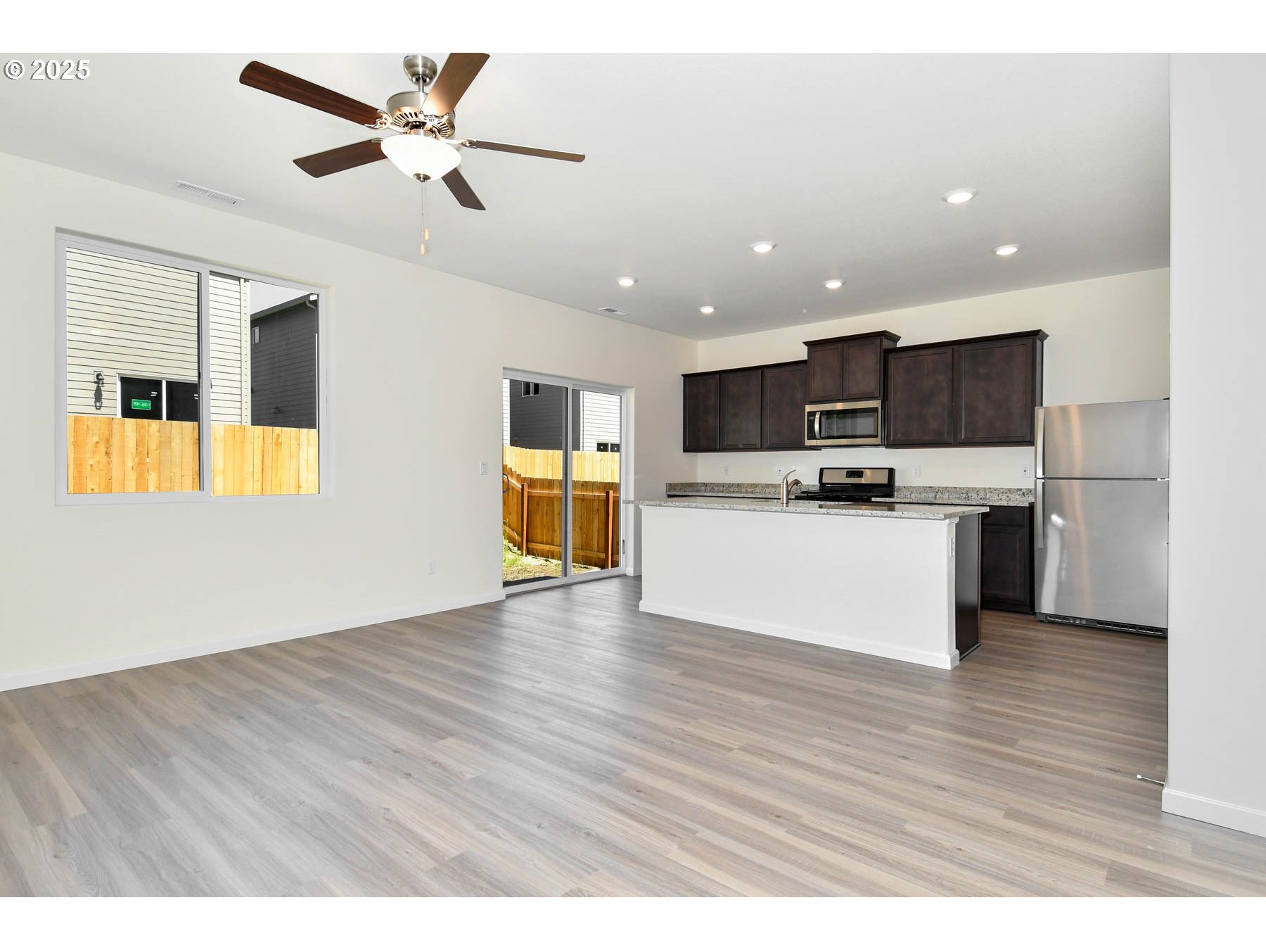 3989 Southwest Duniway Lane Gresham, OR 97080 - Photo 14 of 19 a view of kitchen with microwave oven a stove and white cabinets