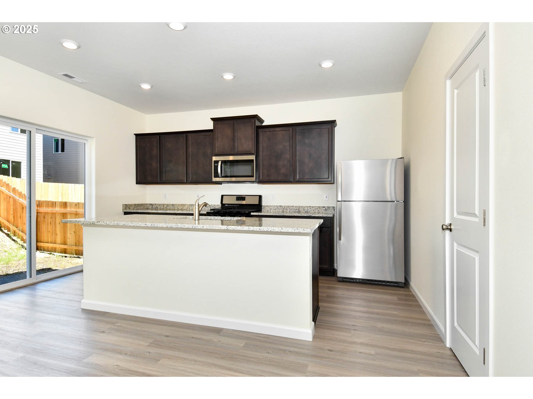 3989 Southwest Duniway Lane Gresham, OR 97080 - Photo 15 of 19 a view of kitchen with kitchen island a sink wooden floor and refrigerator