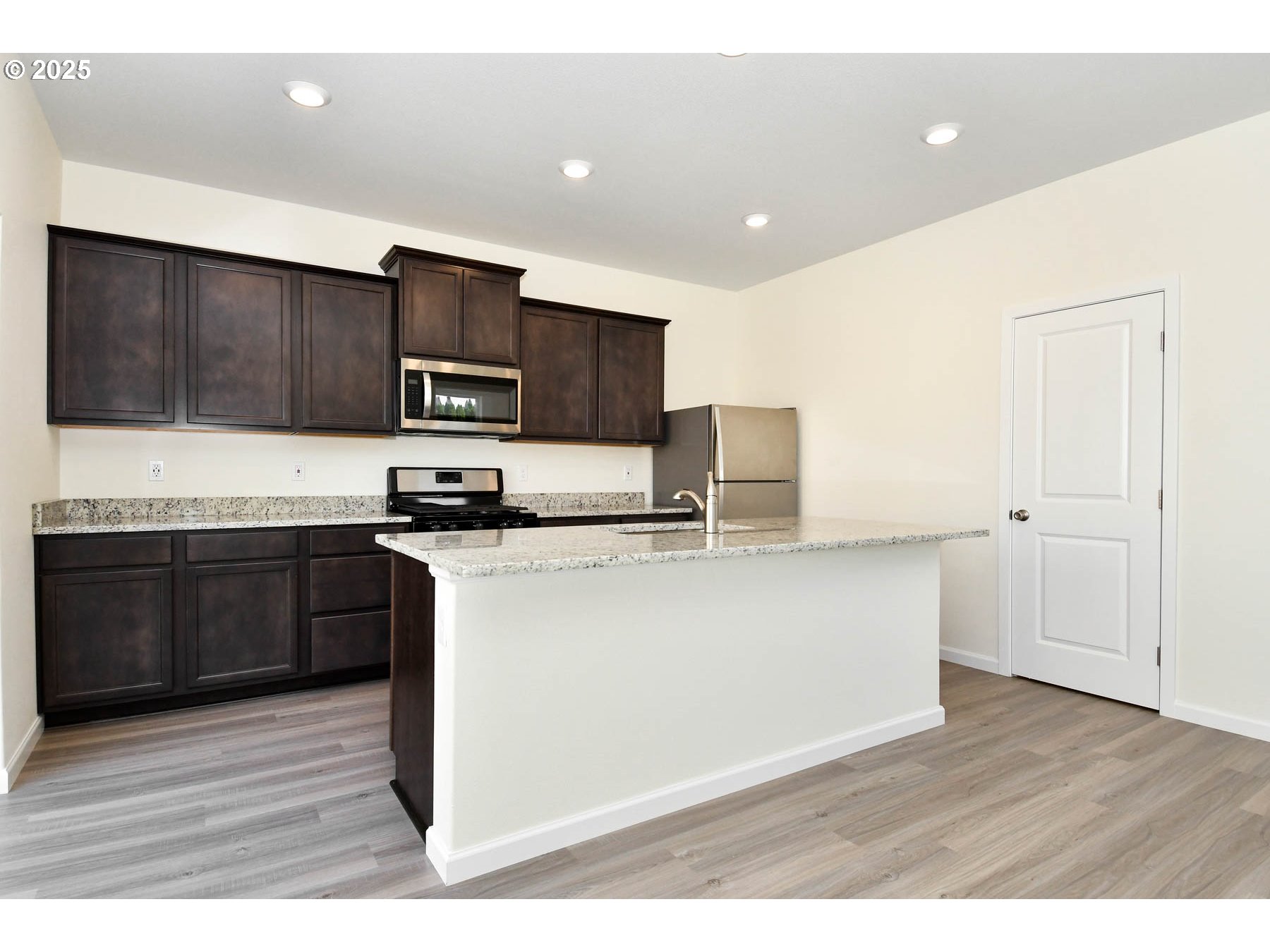 3989 Southwest Duniway Lane Gresham, OR 97080 - Photo 17 of 19 a kitchen with stainless steel appliances kitchen island granite countertop a stove a sink and a refrigerator