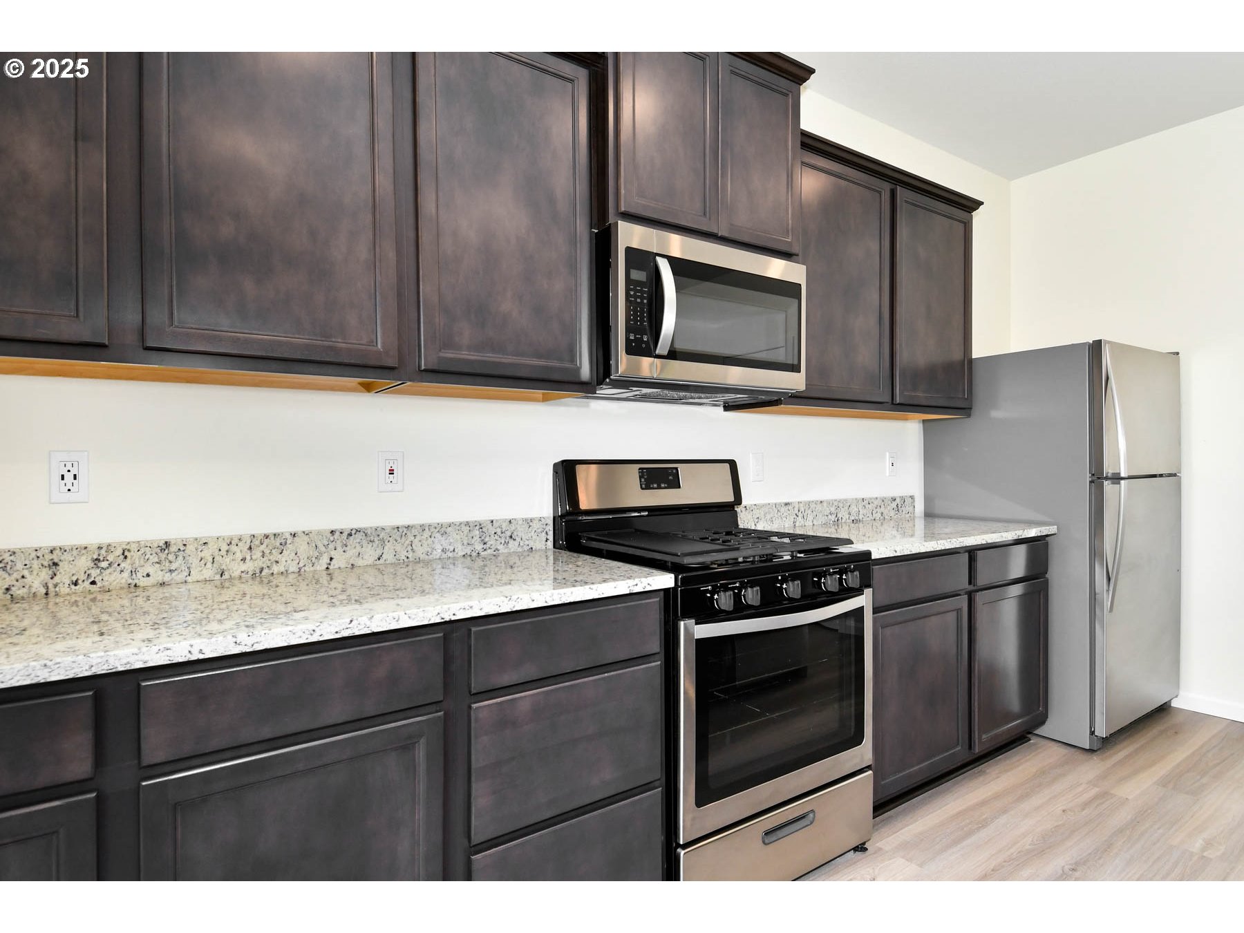 3989 Southwest Duniway Lane Gresham, OR 97080 - Photo 18 of 19 a kitchen with a stove microwave and refrigerator