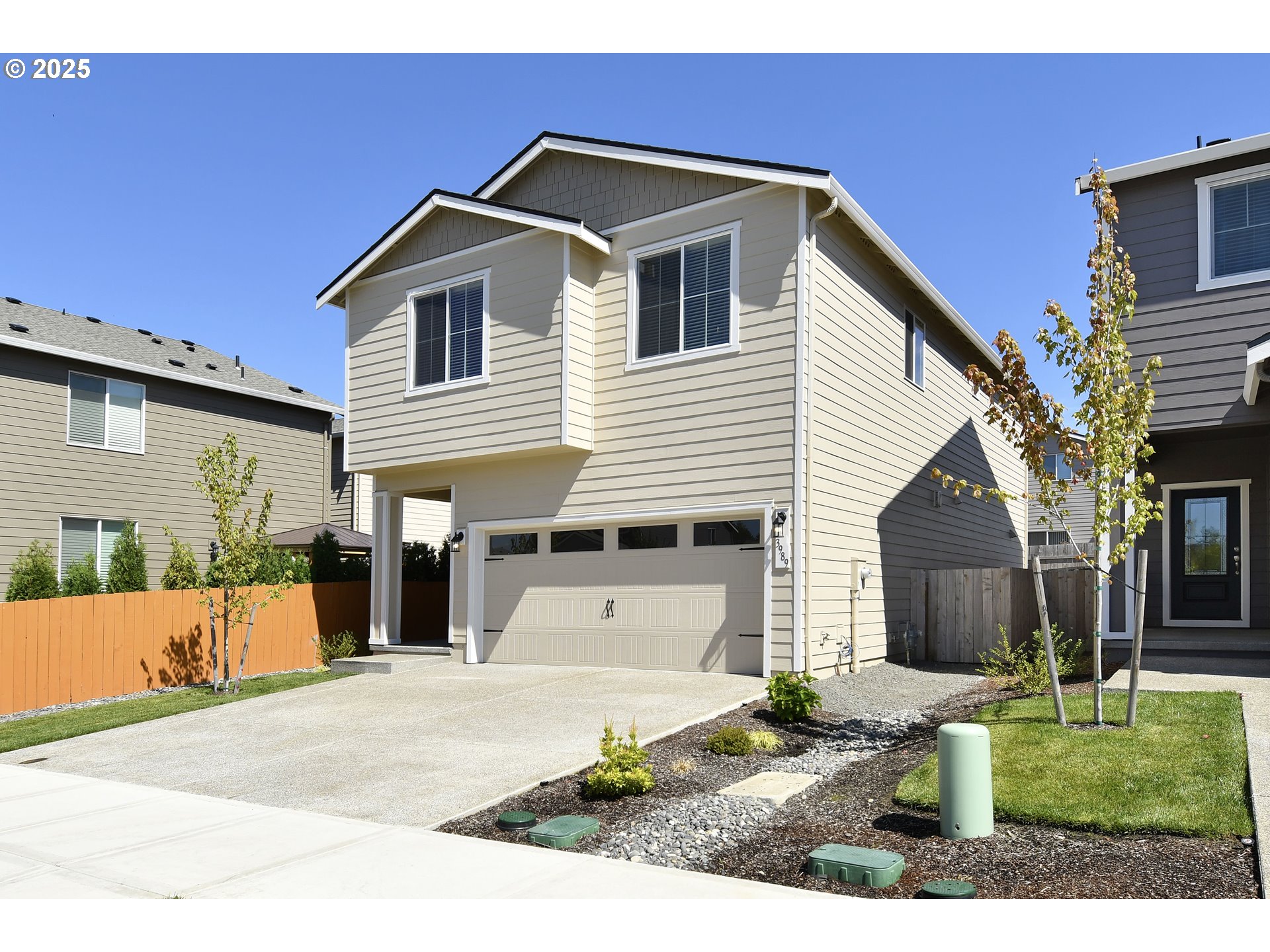 3989 Southwest Duniway Lane Gresham, OR 97080 - Photo 2 of 19 a front view of a house with a yard