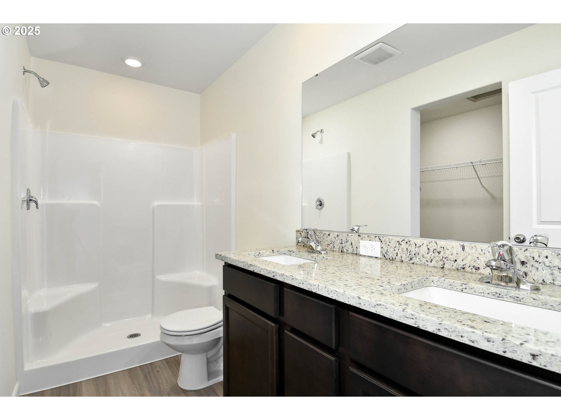 3989 Southwest Duniway Lane Gresham, OR 97080 - Photo 7 of 19 a bathroom with a granite countertop sink toilet a large mirror a bathtub and shower