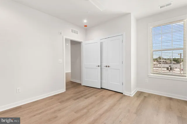 a living room with furniture a flat screen tv and a large window
