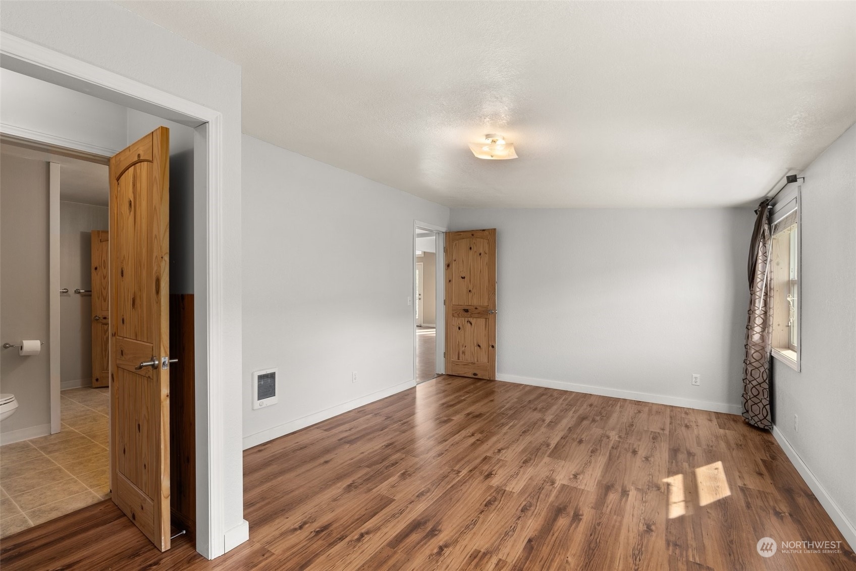 370 Manners Road Rochester, WA 98579 - Photo 19 of 34 a view of an empty room with wooden floor and a window