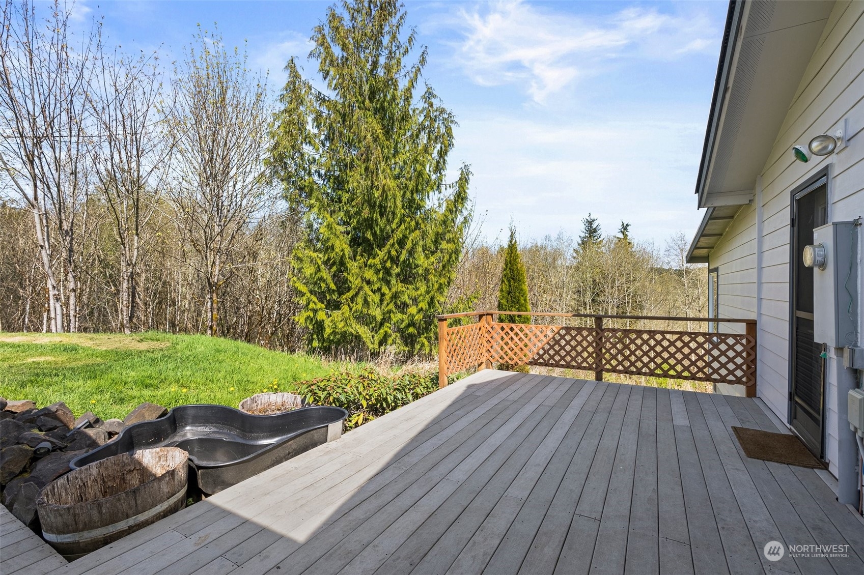 370 Manners Road Rochester, WA 98579 - Photo 28 of 34 a view of a deck with couches plants and wooden fence