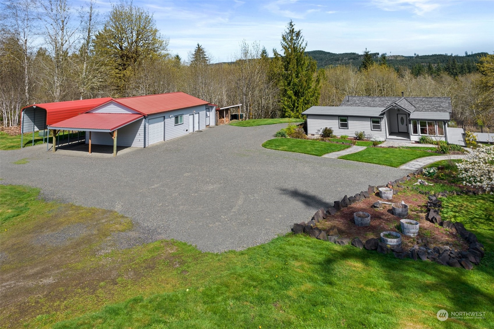 370 Manners Road Rochester, WA 98579 - Photo 29 of 34 an aerial view of a house with a garden and lake view