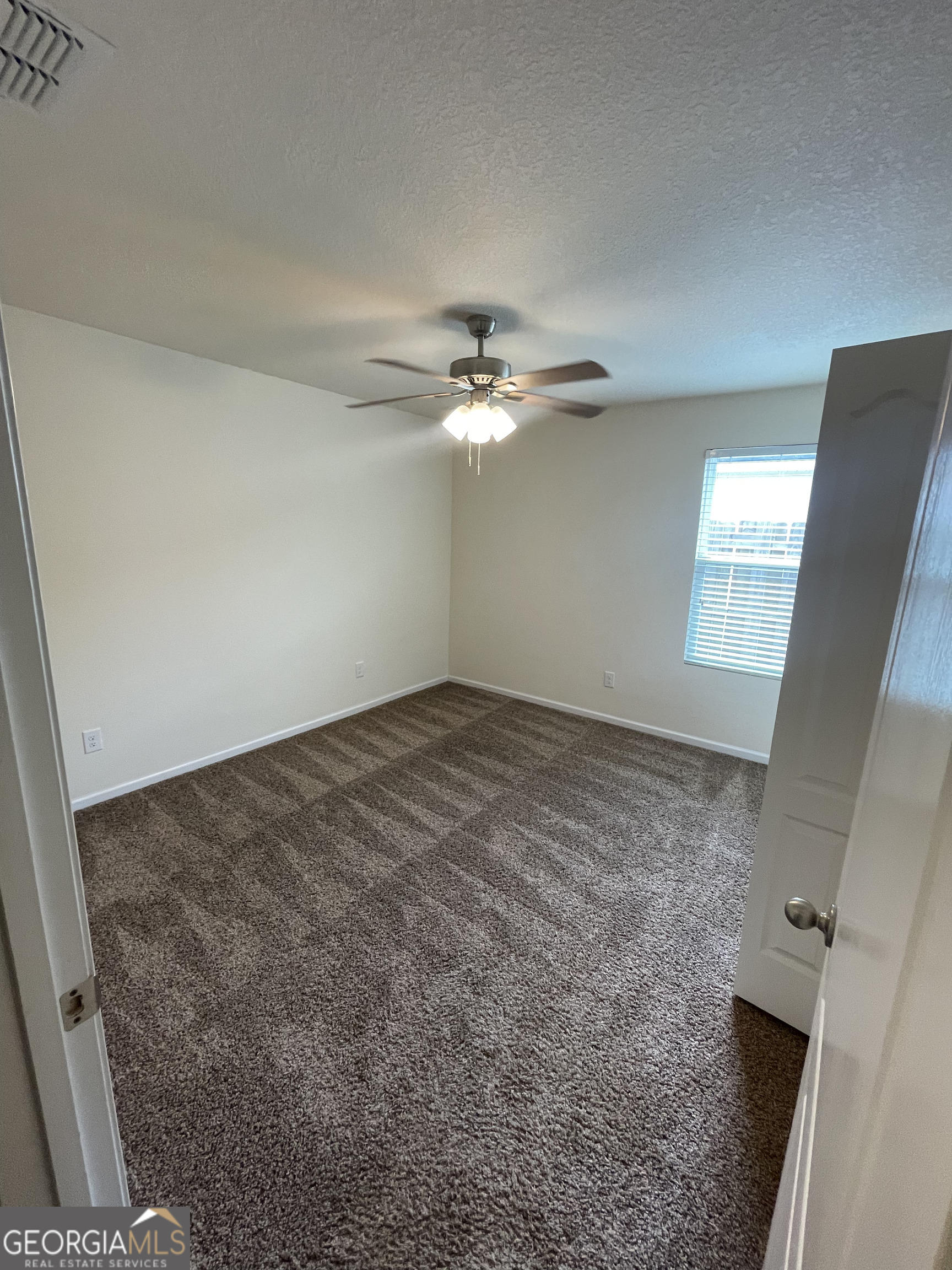 25 Fox Path St. Marys, GA 31558 - Photo 18 of 22 a view of a livingroom with a ceiling fan and window