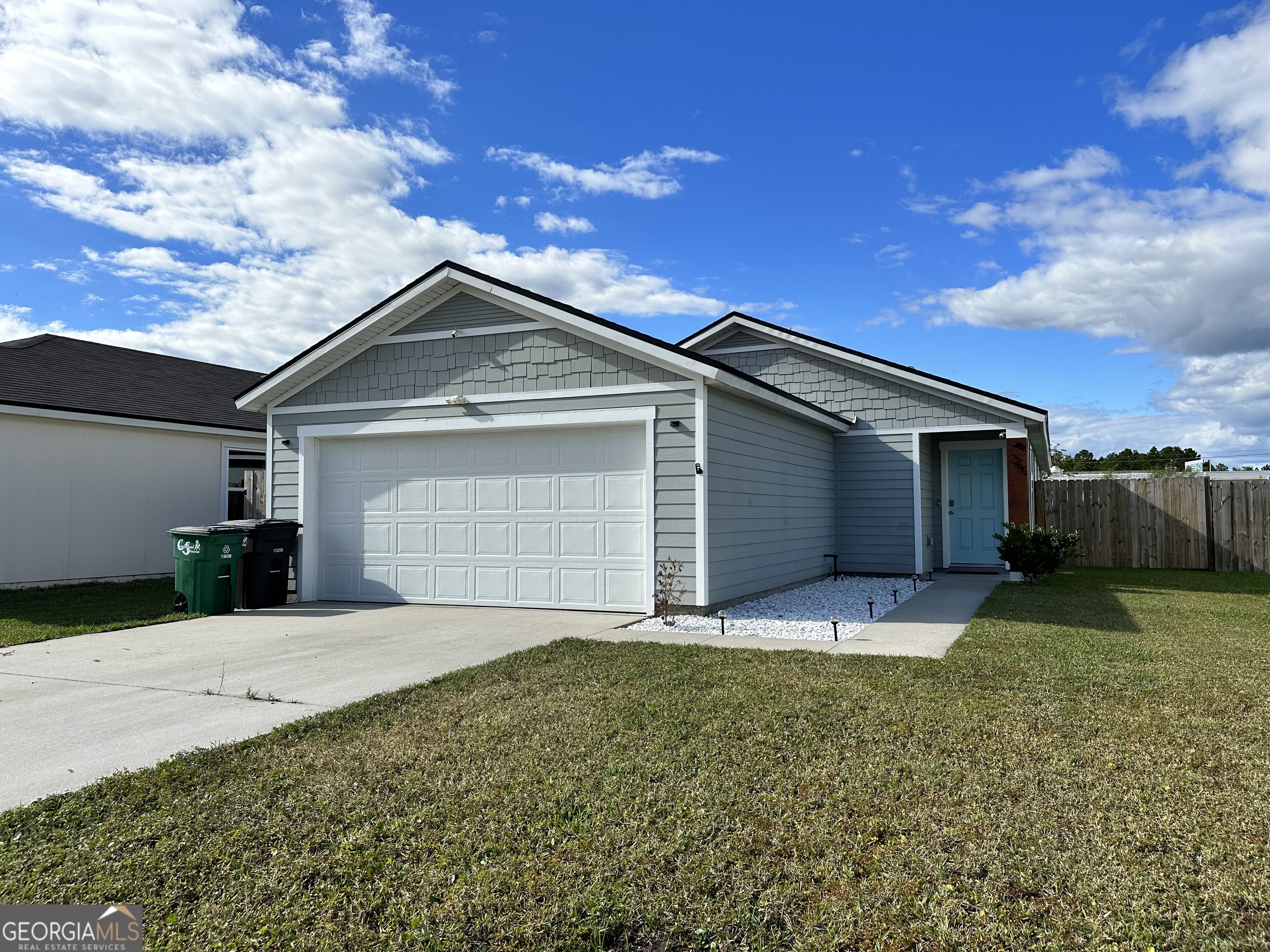 25 Fox Path St. Marys, GA 31558 - Photo 2 of 22 a front view of a house with a yard and garage