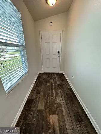 a view of a hardwood floor in a room