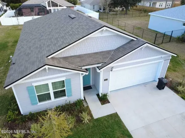 a aerial view of a house with a yard