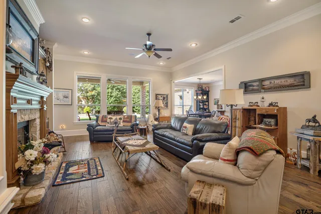 a living room with furniture fireplace and a large window