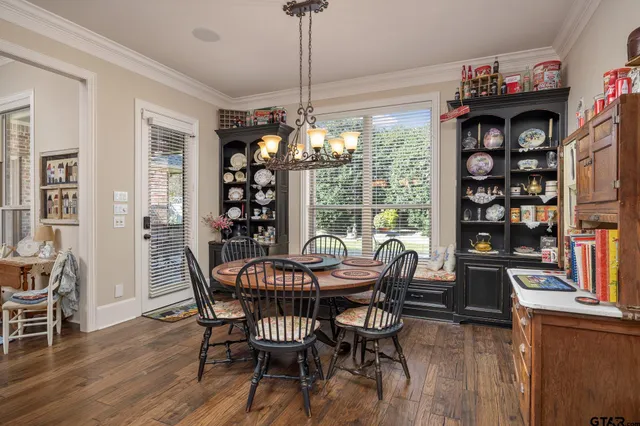 a view of a dining room with furniture large window and wooden floor