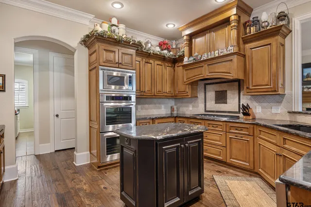 a kitchen with stainless steel appliances granite countertop a stove and a sink