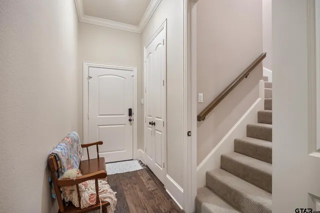 a view of a hallway with wooden floor and entryway